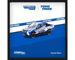 (Preorder) Tarmac Works 1:64 Toyota Hilux TOYO Tires – Blue with Graphics – Hobby64